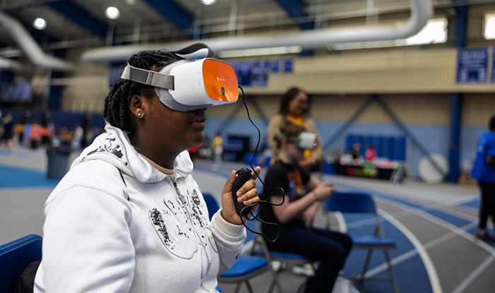 Focus on young teen girl with a VR headset